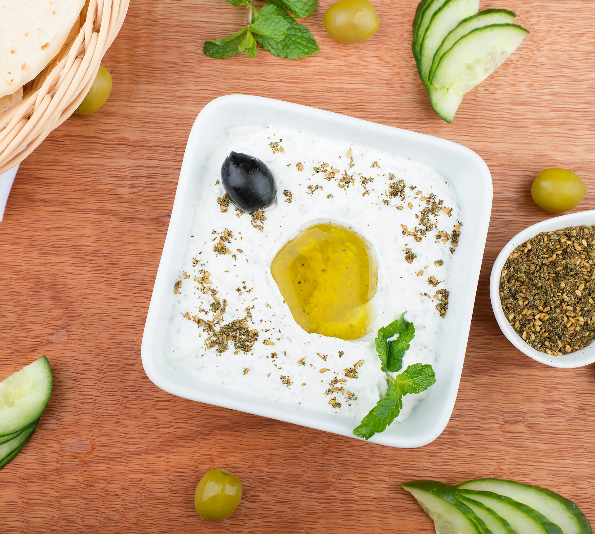 Labneh and mezze plate with olive oil drizzle and warm pita