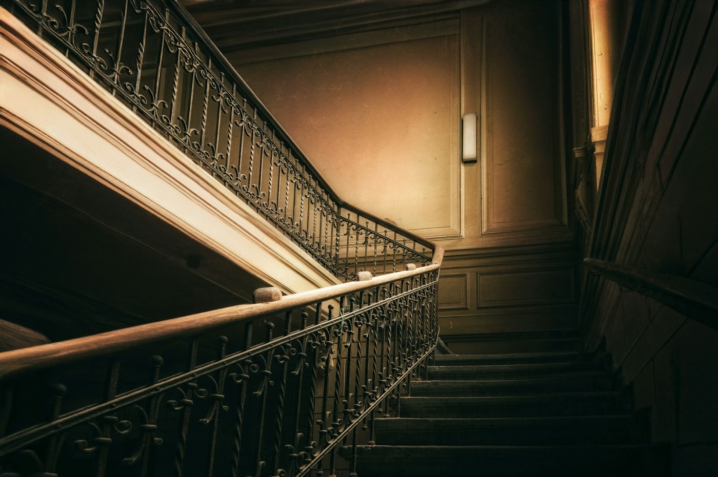 Wrought iron staircase with hand-forged scrollwork at ARCANA